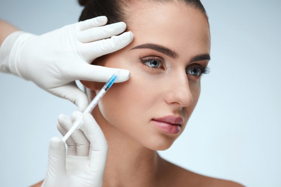 A beautiful woman is having filler injections in the skin