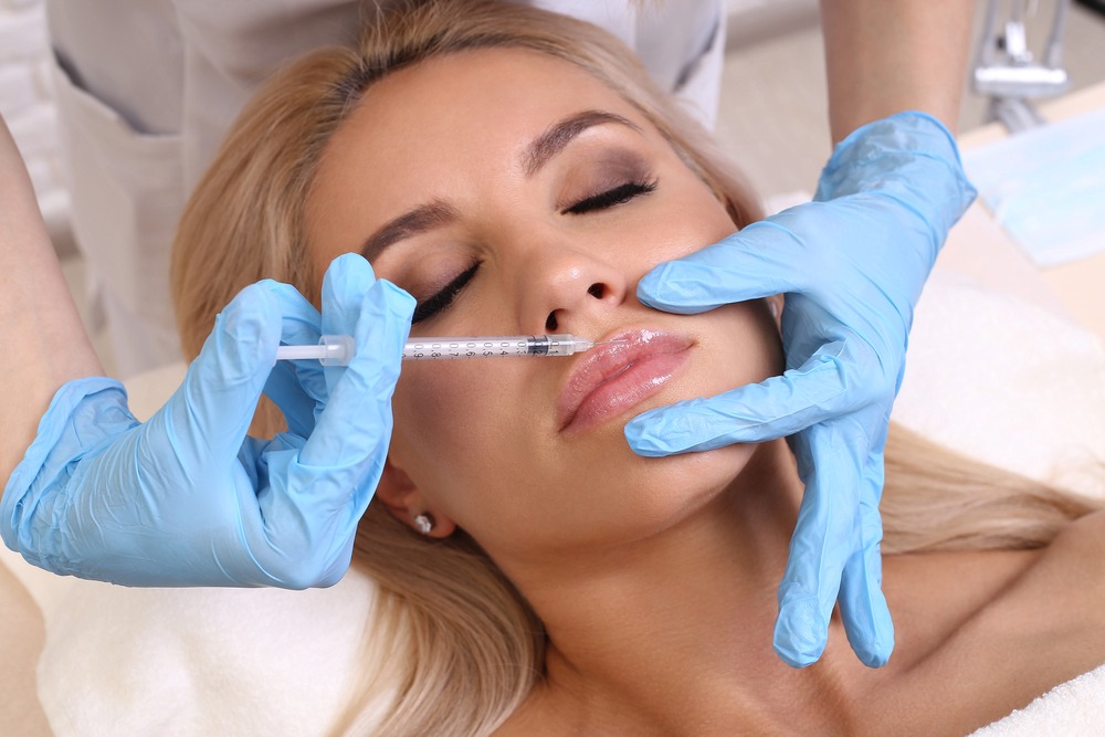 A woman is having a lip augmentation procedure in Harley Street London